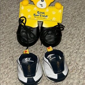 Two pair of build a bear shoes. The black ones are new with tags.